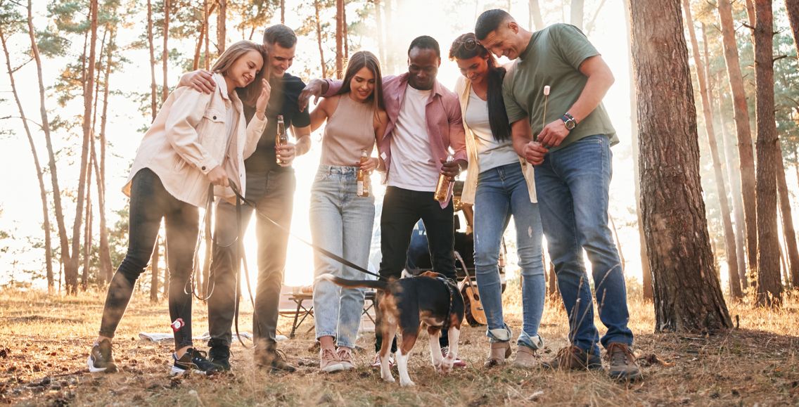 Friends and their dog outside a converted barn in the Peak District